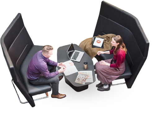 Image of two people discussing in a collaborative workspace