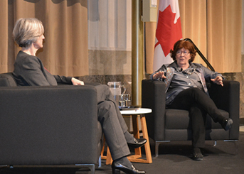 Photograph featuring the Parliamentary Librarian, Dr. Heather Lank, speaking with the Honourable Louise Arbour 