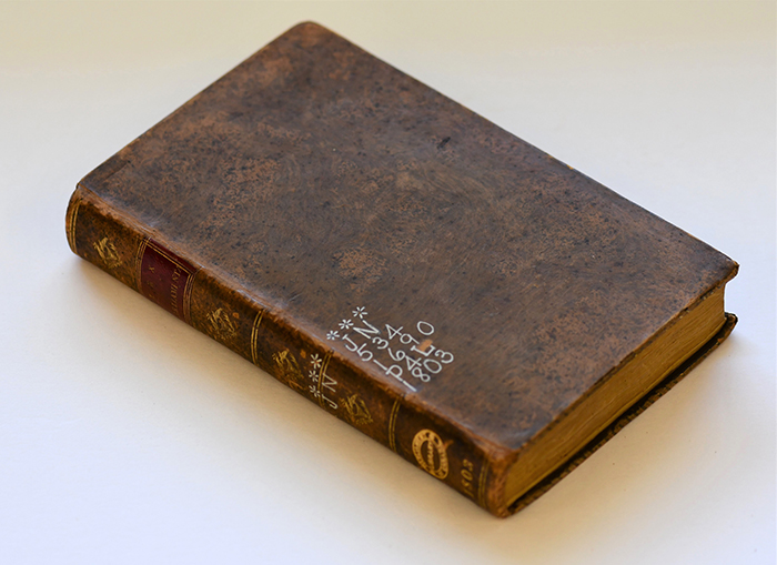 brown leather book on a white surface