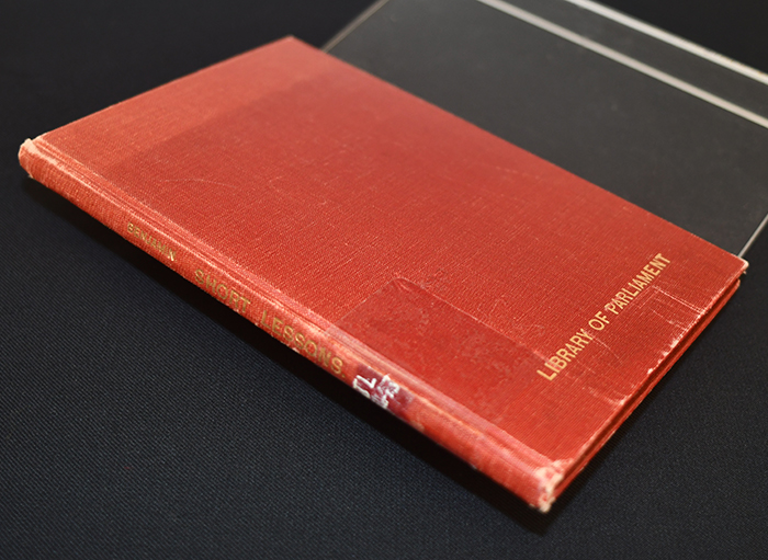 Closed red book on a black surface
