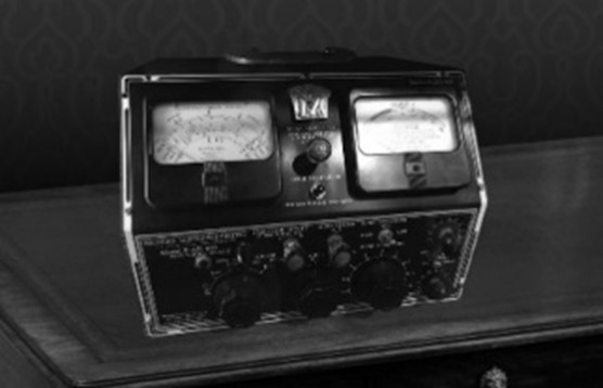 Scientific instrument with two gauges and numerous dials.